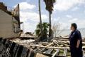 FEMA Individual Assistance specialist at a damaged home in Texas