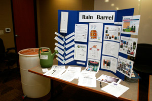 Tabletop display with rain barrel information poster