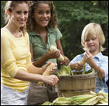 Photo: Children husking corn