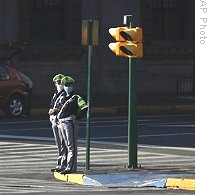 Police officers, wearing mask as a precaution against the swine flu, patrol a street in Mexico City, Sunday, 03 May 2009