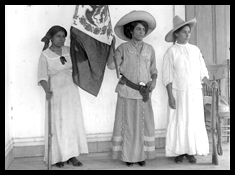 Three woman soldiers holding a Mexican flag