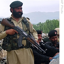 Pakistani paramilitary maintain a position on a high post in the troubled area of Pakistan's Lower Dir district, 26 Apr 2009