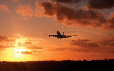 Airliner taking off into sunset