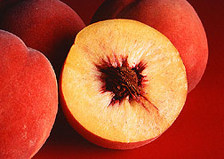 Cut open peach with stone fruit