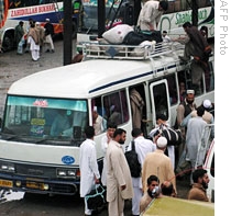 Local residents board the bus as they flee the troubled Mingora town, 05 May 2009
