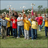 Photo: A fourth grade group from Tipton Elementary School in Tipton, Oklahoma try out their anemometers that were made as one of the hand-on activities during Earth Day festivities at Blue Canyon Wind Farm.