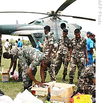 Sri Lankan Air Force soldiers load food onto a military helicopter at the northern military air base in Anuradhapura, 05 May 2009