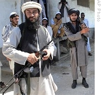 Taliban militants hold weapons outside mosque where tribal elders and Taliban met in Daggar, Buner&#39;s main town, 23 Apr 2009