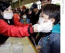 Workers of S. Korean baseball team LG Twins distribute masks at Chamsil stadium in Seoul, 02 May 2009