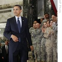 President Barack Obama is applauded by military personnel during his visit to Camp Victory in Baghdad, Iraq, 07 Apr 2009