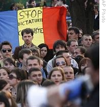 Anti-communist demonstrators hold a flag which reads 'Stop the Communist Dictatorship' outside the presidential palace in Chisinau, Moldova, 06 Apr 2009