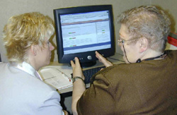 Two women using a computer.