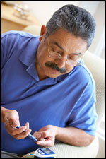 Photo: A man testing his blood sugar level