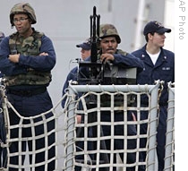 Sailors stand on deck of the USS Bainbridge as it sails into Mombasa harbor, 16 Apr 2009
