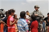 Spc. Nicole Willson hands out donated toys to local Iraqi children.