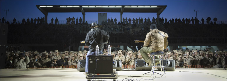 Grammy award-winning musician Kid Rock and Zac Brown entertain Marines and sailors stationed at Al Asad Air Base, Iraq, Dec, 19, 2008. U.S. Navy Adm. Mike Mullen, chairman of the Joint Chiefs of Staff,  along with his wife Deborah, welcomed musician Zac Brown; comedians John Bowman, Kathleen Madigan and Lewis Black; actress Tichina Arnold; American Idol contestant and country musician Kellie Pickler on the tour. The group brought music and entertainment to servicemembers and their families stationed overseas. DoD photo by Petty Officer 1st Class Chad J. McNeeley