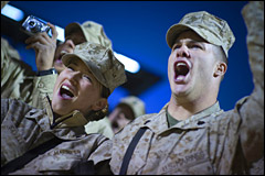 U.S. Marine Corps Cpl. Chantel Saville (left) and Sgt. Jonathan Oaks cheer at the introduction of Grammy award-winning musician Kid Rock and Zac Brown during the 2008 USO Holiday Tour stop at Al Asad Air Base, Iraq, Dec, 19, 2008. DoD photo by Petty Officer 1st Class Chad J. McNeeley
