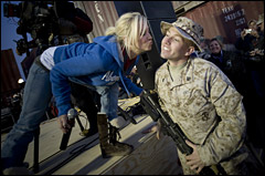 American Idol contestant and country musician Kellie Pickler grants a Christmas wish for a kiss to U.S. Marine Sgt. Christopher Lambert at the 2008 USO Holiday Tour stop at Al Asad Air Base, Iraq, Dec. 19, 2008. DoD photo by Petty Officer 1st Class Chad J. McNeeley