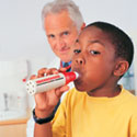 Doctor treating boy with asthma