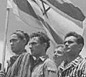 Jewish refugees from Europe aboard the RMS <i>Mataroa</i> hold a Zionist flag as their ship legally enters the port of Haifa, July 1945.