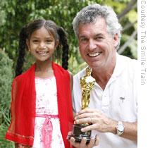 Mullaney - posing with Pinki, a girl from rural India whose cleft surgery was the subject of Megan Mylan's documentary film - holds the Oscar for Best Documentary Short