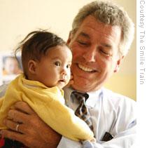 Brian Mullaney hold a cleft patient in Kabul, Afghanistan during a 2007 visit