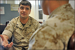 Marine Sgt. Vincent Schneider talks with a fellow Marine Cpl. Chris Boreland at the Wounded Warrior Battalion East, Camp Lejeune, N.C. Schneider is a wounded Marine but works as the barracks manager there. Of the Marines there about two-thirds have part-time jobs or attend college. Staying active is key to healing, officials said. DoD photo by Fred W. Baker III