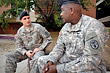 Army Capt. Chris Toma, commander of Able Troop, Warrior Transition Brigade, at Walter Reed Army Medical Center, talks with platoon sergeant Sgt. 1st Class Frank Boyd about soldier issues. The Army transformed its wounded warrior care into a system that puts the soldiers and family members at the center of care, surrounded by protective layers of leadership, case managers, doctors, support specialists and senior leader oversight. DoD photo by Fred W. Baker III