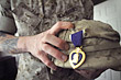 Marine Sgt. Jack Durgala shows where a piece of metal penetrated his Kevlar helmet. Durgala is stationed at the Wounded Warrior Battalion East at Camp Lejeune, N.C., where he is recovering from wounds he suffered in combat in November 2005. DoD photo by Fred W. Baker III