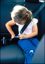 Photo: A girl putting on a seat belt