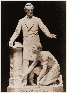 picture - Sculpture of Abraham Lincoln standing above crouched slave wearing manacles 