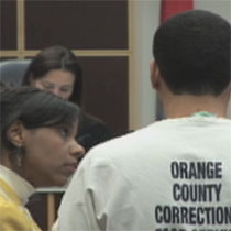Ody Arias-Luciano interprets for a Spanish-speaking defendant before a judge in Orlando, Florida