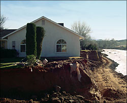 Image of structure damaged by bank erosion.