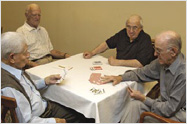 Photo of elderly men playing cards