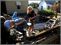 Photo of children digging through debris.