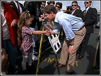 Photo of a little girl shaking Al Gore's hand.