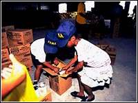 Photo of two children trying to pack a box.