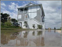 Photo of an elevated house protected from flood waters.