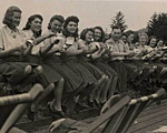 The SS female auxiliaries show with mock sadness that they have finished eating their blueberries, July 22, 1944.