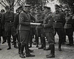 September 1, 1944, Richard Baer ceremonially accepts a copy of the construction plans from the Chief of the Central Construction Directorate of the Waffen SS, SS-Sturmbannführer Karl Bischoff, celebrating the opening of an SS military hospital (SS-Lazarette).