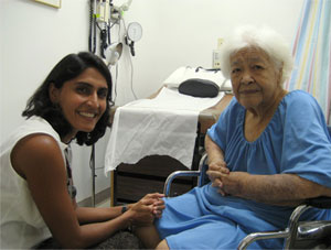 Photo of Dr. Divya Sharma treats a patient in Saipan