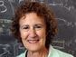 Photo of Barbara Liskov of MIT in front of a chalk board.