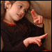 Photo: A young girl using sign language