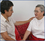 Photo of a younger woman talking with an older woman