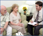 Photo of a counselor talking to an older couple