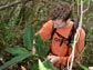 Photo of Joshua Atwood removing an invasive plant from Manoa Valley on the island of O'ahu.