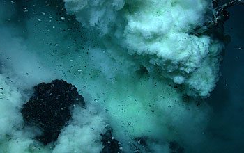 Jason's arm samples NW Rota-1; the dark rocks are lava.