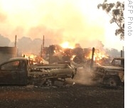 Vehicles and a barn burn in bushfires close to Labertouche, some 125 kilometres west of Melbourne, Australia, 07 Feb 2009