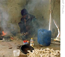 An Illegal Zimbabwean worker prepares a meal on a farm near the S. Africa-Zimbabwe border, (File)