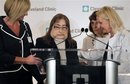 Connie Culp ,second from left, who underwent the first face transplant surgery in the U.S., is helped to the podium by her head surgeon, Dr. Maria Siemionow, right, as well as Renee Bennett, the nurse manager for the Clinic's transplant program, far left, and Pat Lock, a nurse with the transplant team, third from left,  before speaking to the media at a news conference at the Cleveland Clinic in Cleveland,  on Tuesday, May 5, 2009. The 46-year-old mother of two lost most of the midsection of her face to a gunshot in 2004. The initial surgery by the Cleveland Clinic team took place in December 2008.  (AP Photo/Amy Sancetta)